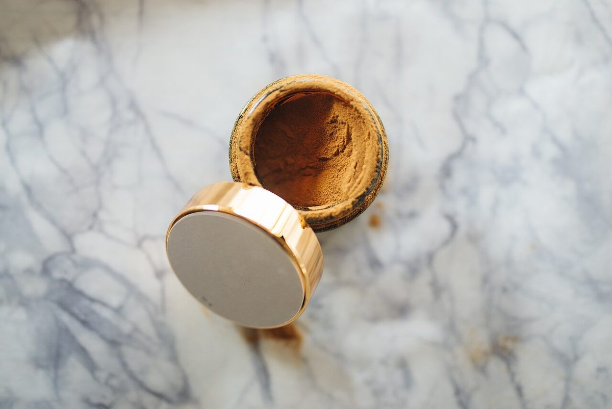 Natural herbal powder container placed on marble surface ready for culinary use and beauty treatments.jpg