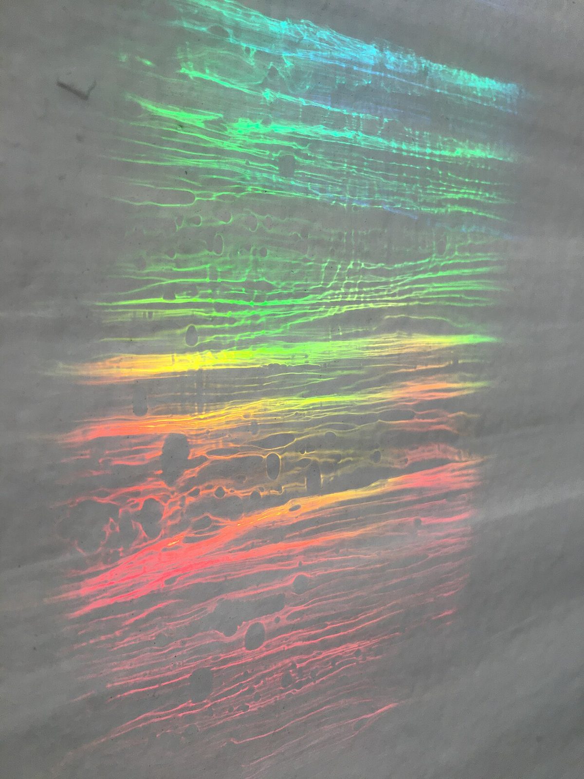 Light spectrum on a wall caused by sunlight going through prism and then handmade glass.jpg