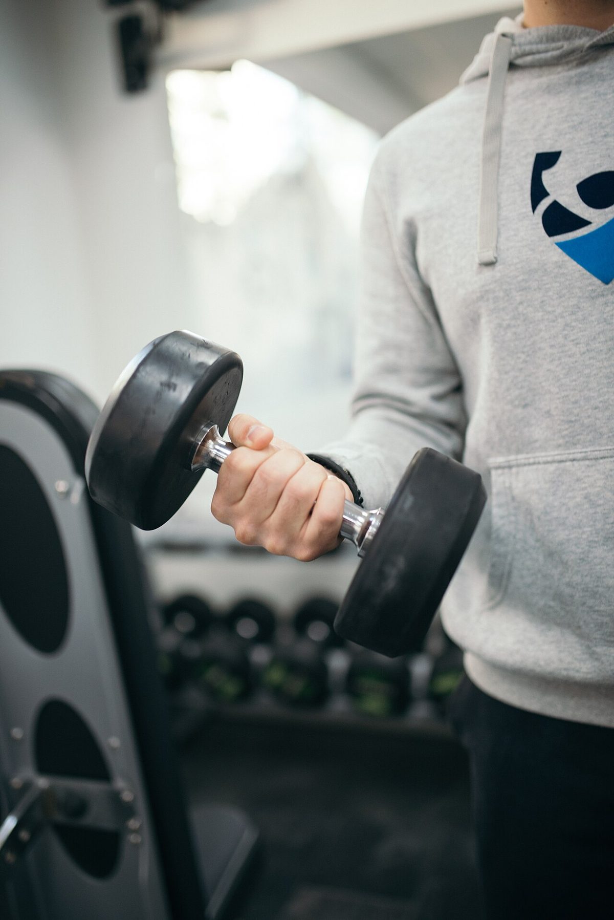 Close-up Hand holding dumbbell in gym.jpg
